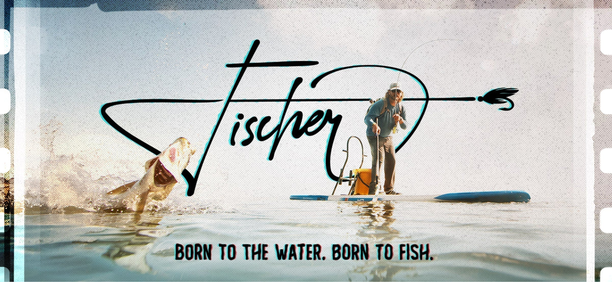 A paddle boarder realing in a fish off of his Fischer paddle board