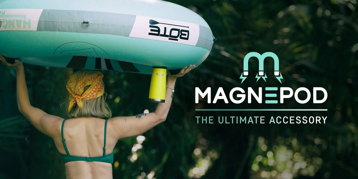 A woman holding a tube upside down over her head with a MAGNETumbler hanging upside down on the MAGNEPOD holder with text overlay that says "MAGNEPOD THE ULTIMATE ACCESSORY"