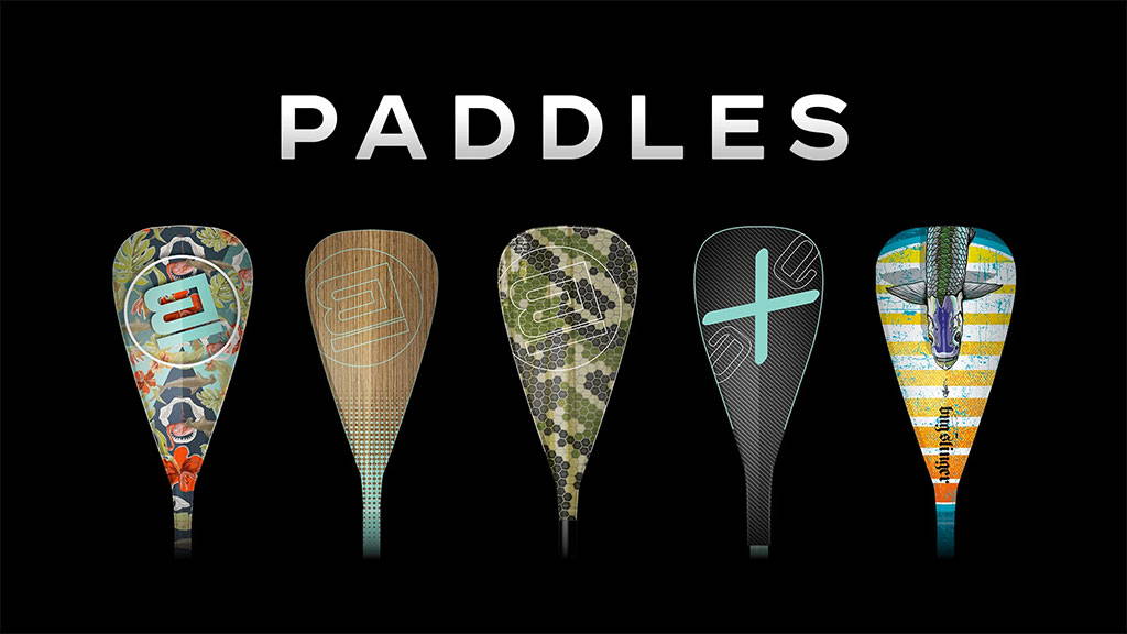 Five patterned paddle blades in different designs with white text reading “PADDLES” on a black background.