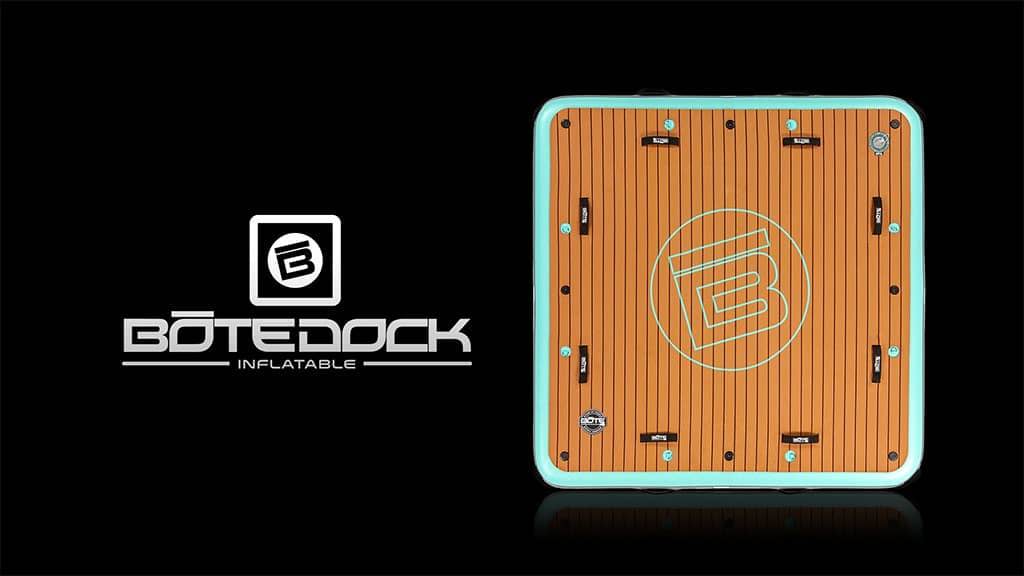 Square floating dock shown from above with faux teak deck and text reading “BoteDock Inflatable.”