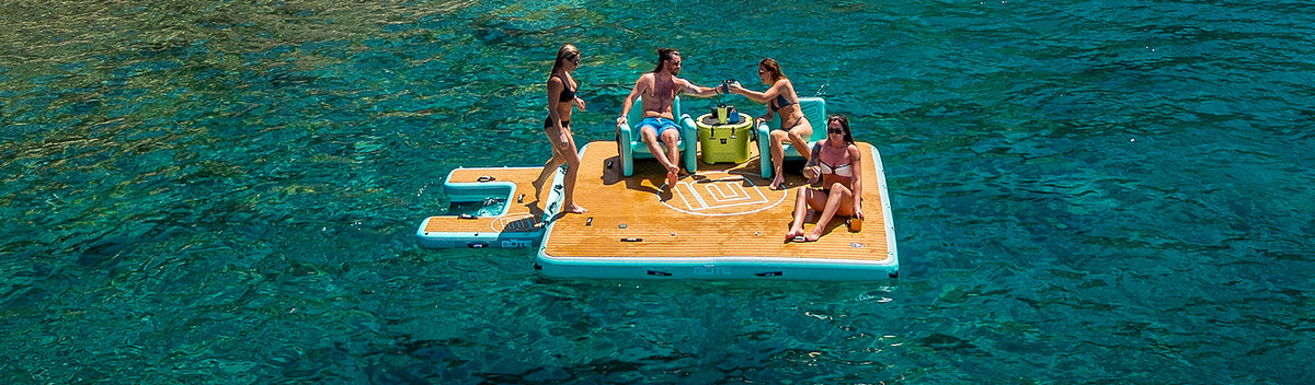 People sitting on a Hangout Dock in clear calm water.