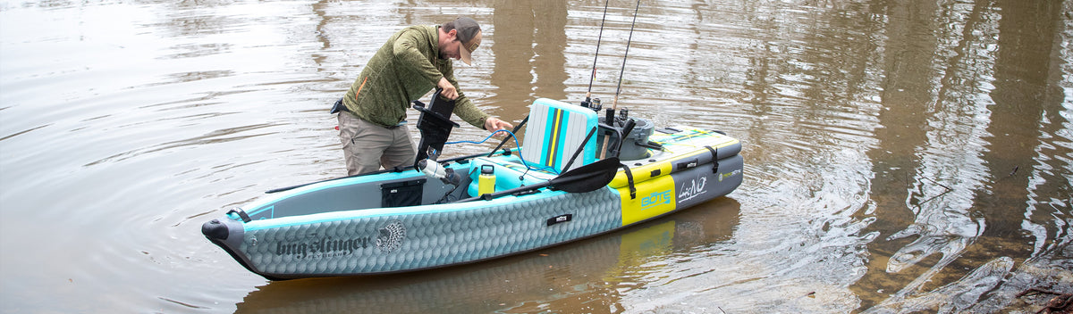 Man adjusting mounted motor on inflatable kayak in calm water.