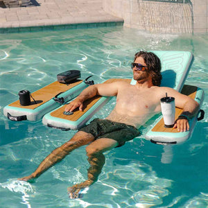 Man lounging on an inflatable chair with cup holders and speakers in a pool.