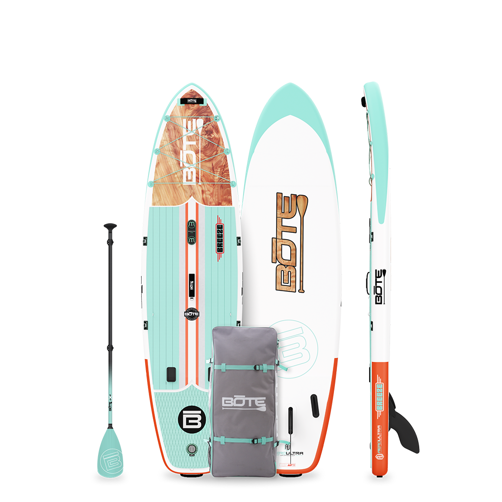 Breeze Aero inflatable SUP in teal/orange with wood graphic, shown with paddle and carry bag.