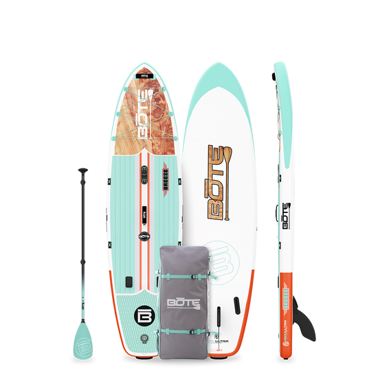 Breeze Aero inflatable SUP in teal/orange with wood graphic, shown with paddle and carry bag.