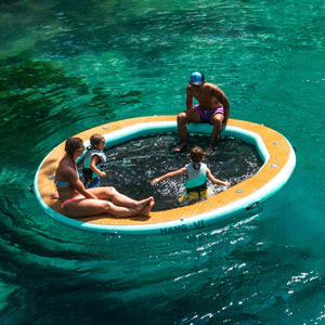 Lifestyle image of people lounging in the Inflatable Hangout Water Hammock 10 Classic