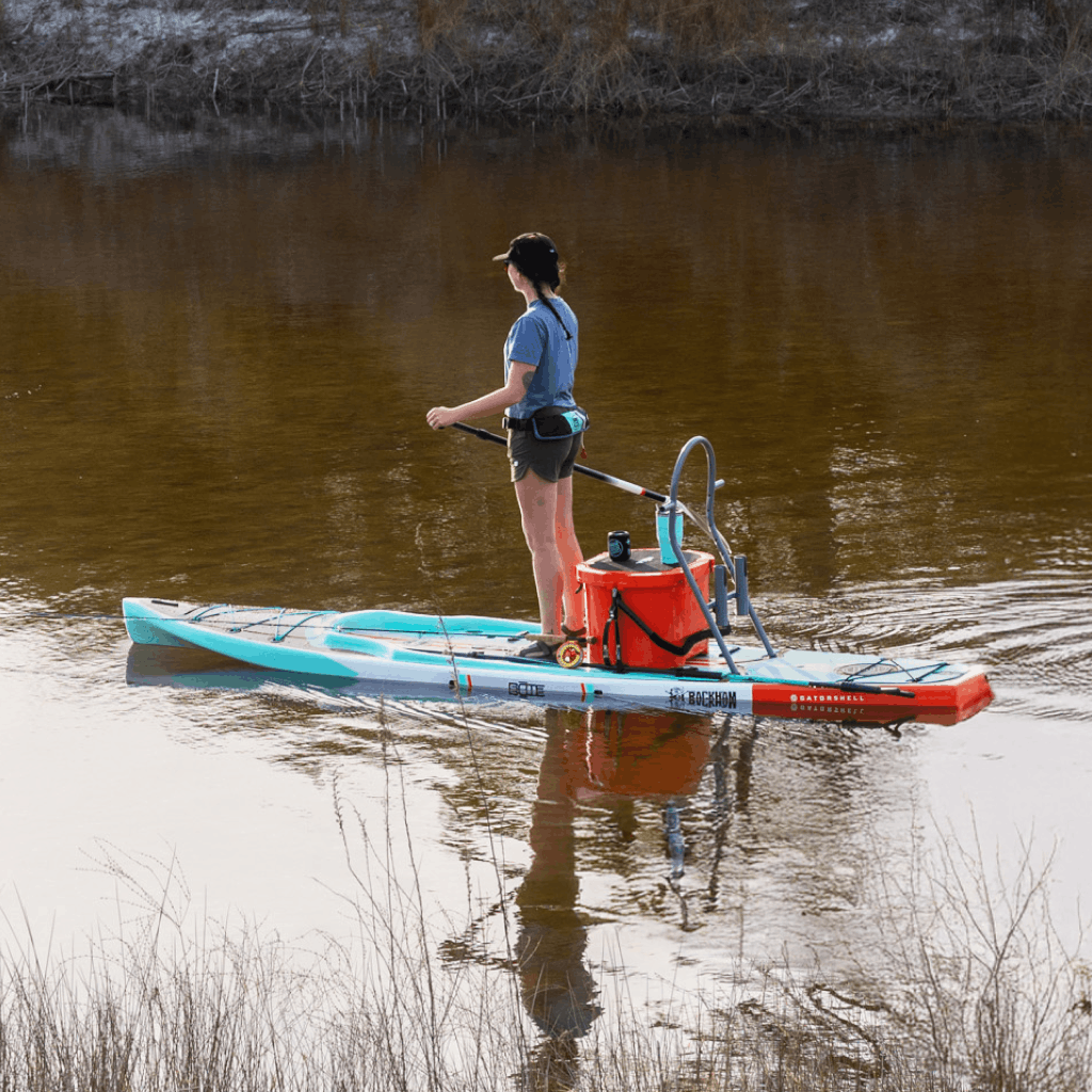 Angled view of Rackham Gatorshell paddle board with cooler and Sandspear on calm water.