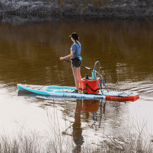 Angled view of Rackham Gatorshell paddle board with cooler and Sandspear on calm water.