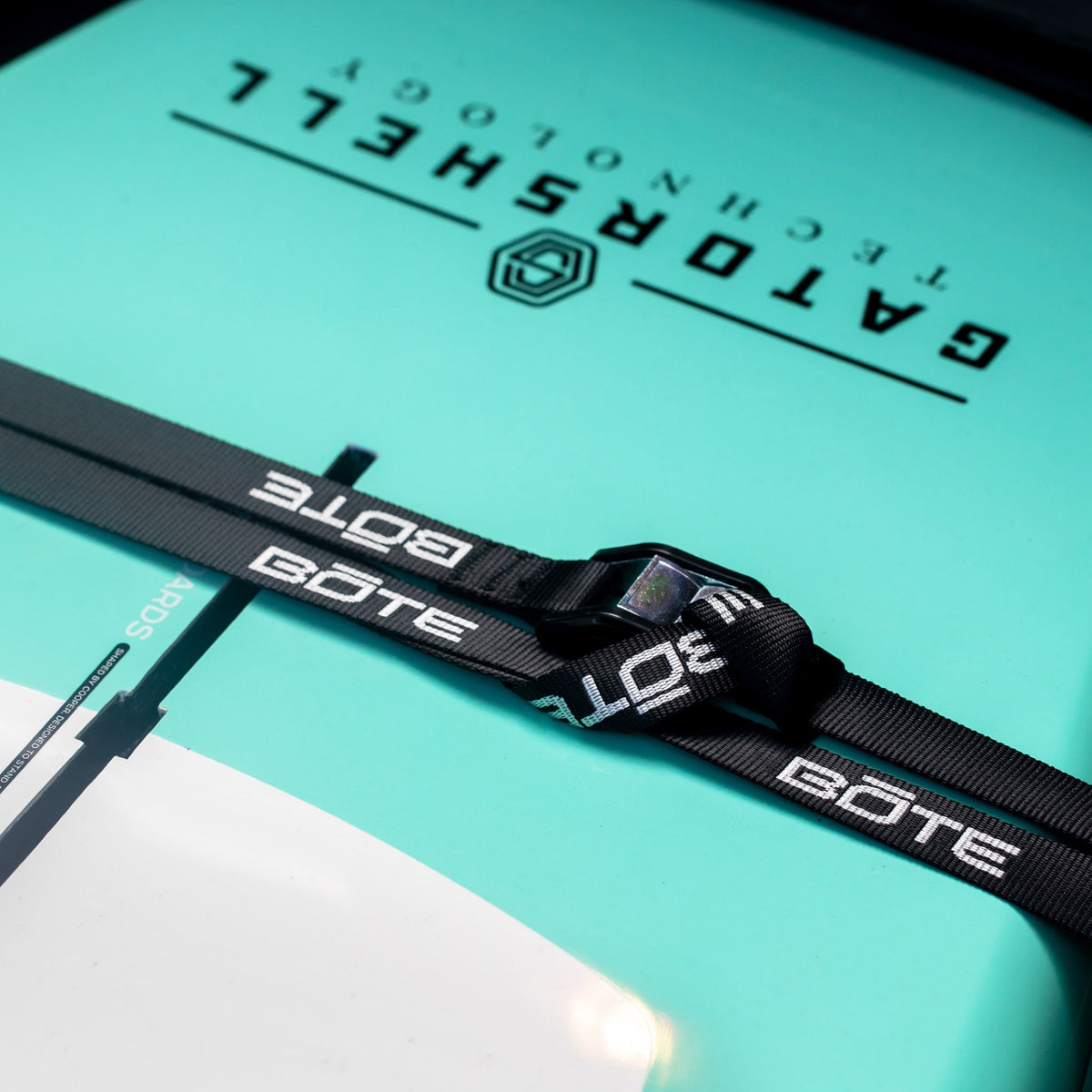 Close-up of Cam Straps secured across a paddle board deck with cam buckle detail.