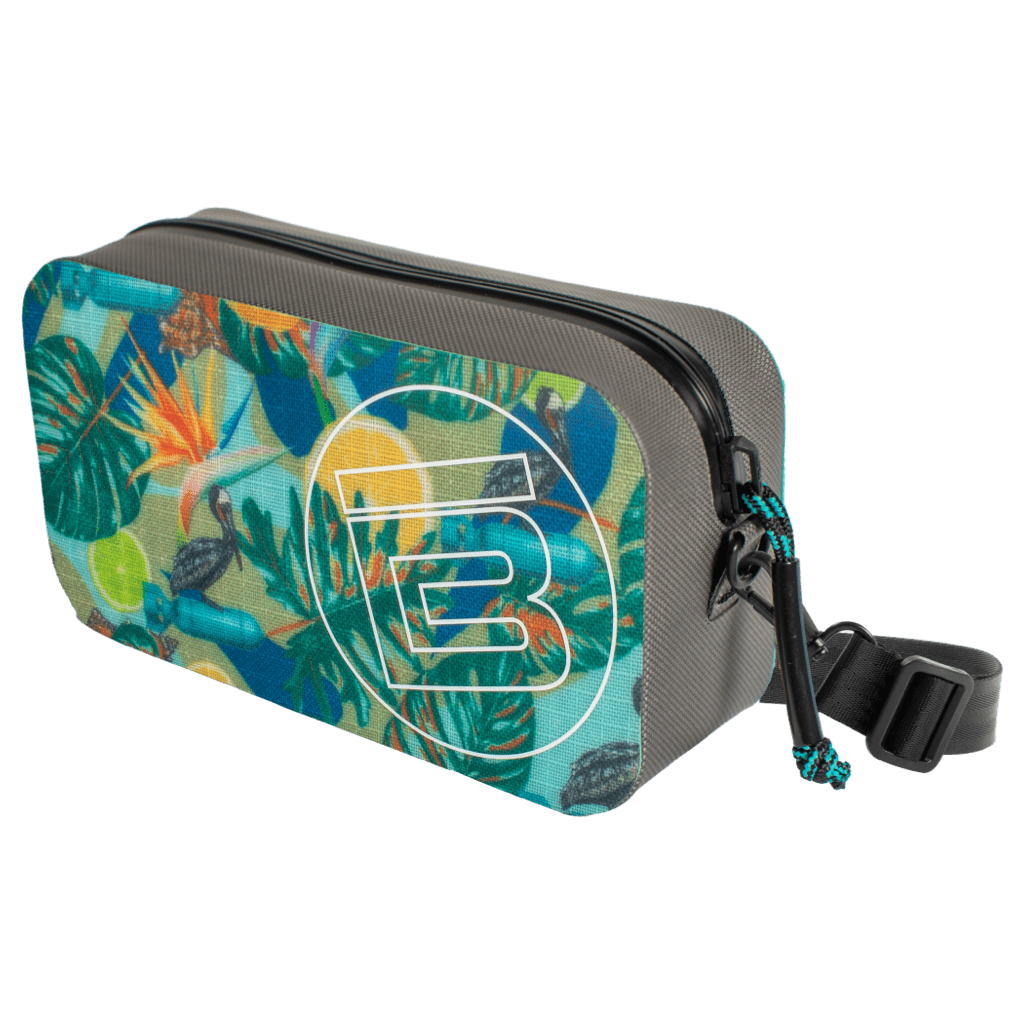 Angled side view of Highwater Hitchhiker Native Bombardier showing zipper and bright tropical pattern.