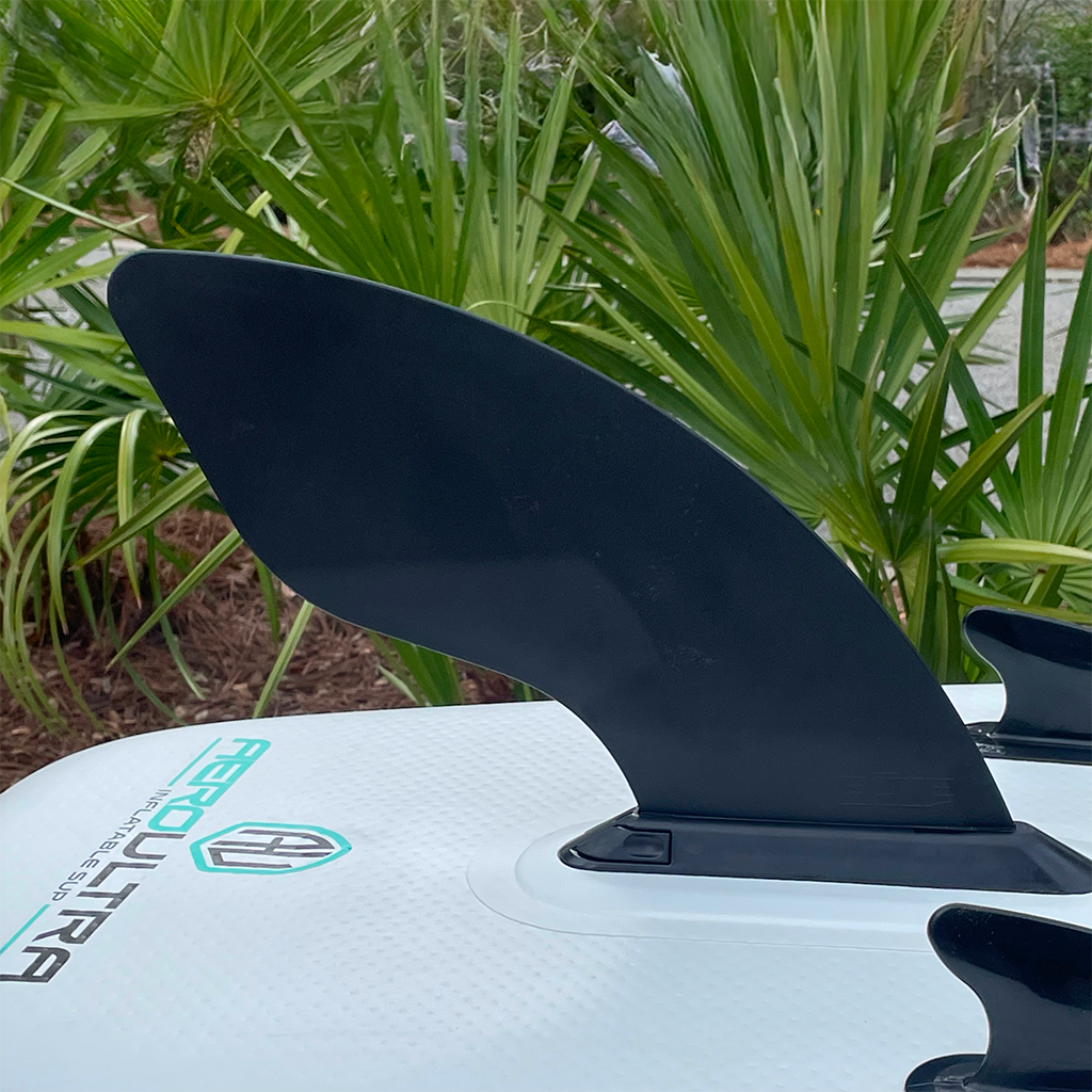 Close-up of 10" Click-In Center Fin installed on an inflatable SUP outdoors.
