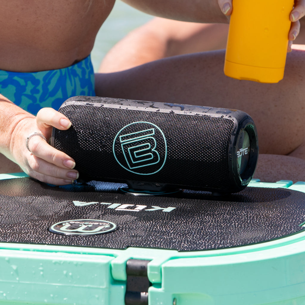 Woman attaching speaker to cooler