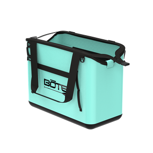 Rear angled view of Mule Tote in mint with black handles and logo on back panel.