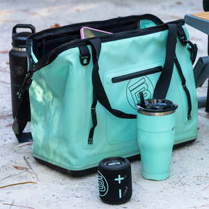 Front angled view of Mule Tote with zipper opening, shoulder straps, and exterior pocket.