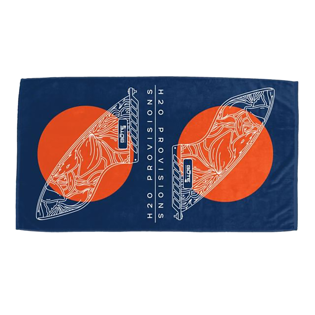 BOTE Fin Woven Towel laid flat, showing navy background with orange sun circles and white fin line art.