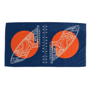 BOTE Fin Woven Towel laid flat, showing navy background with orange sun circles and white fin line art.