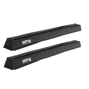 Angled view of a pair of black padded Roof Rack Pads with BOTE logo patches.