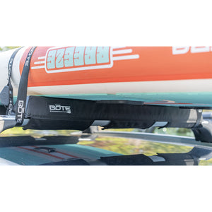 Roof Rack Pads securing an inflatable SUP to a car roof rack with straps.