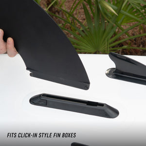 Lifestyle view of Click-In Center Fin being inserted into a click-in style fin box.