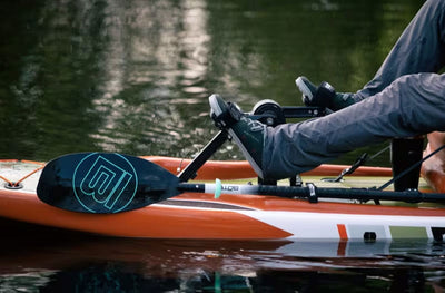 Close-up of the Rackham Gatorshell APEX pedal drive in use with paddle resting on the deck.