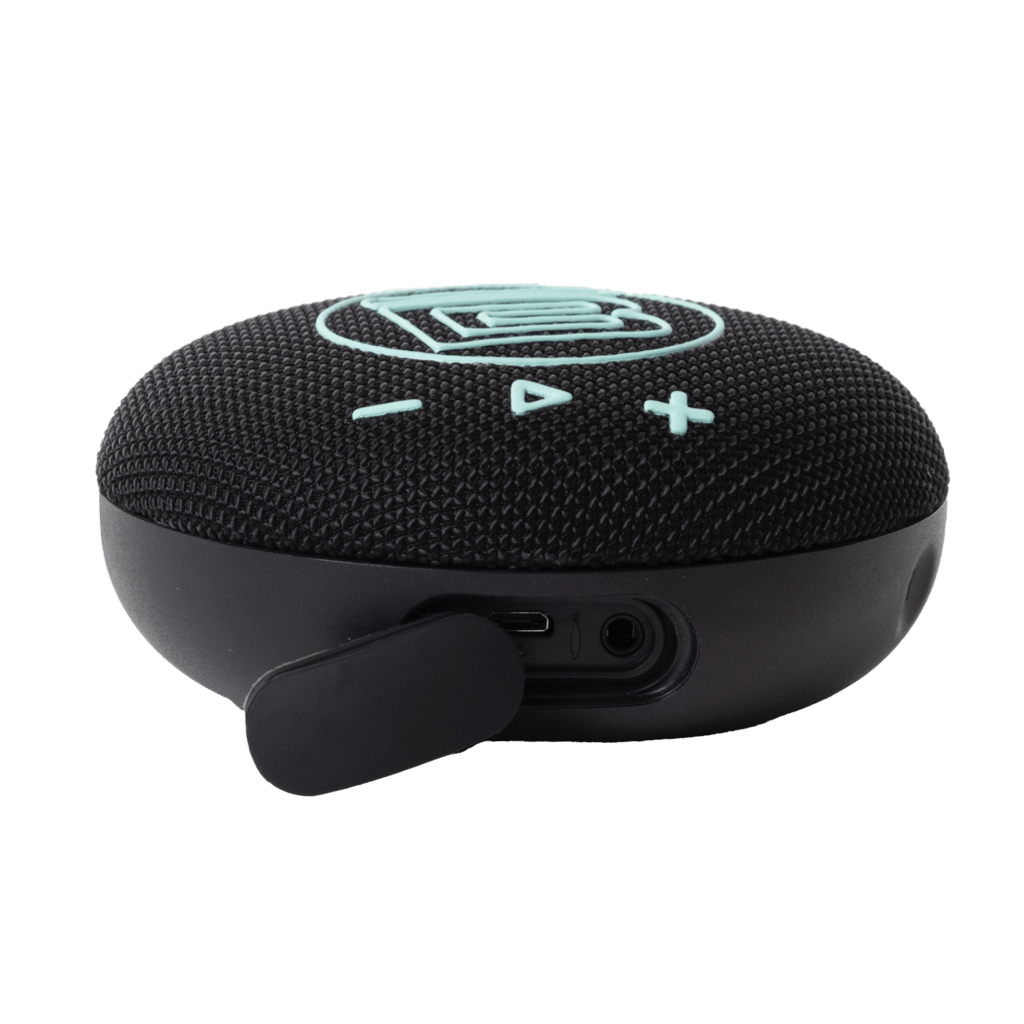 Angled view of speaker showing charging port area