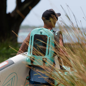Man wearing the Highwater Backpack Seafoam while carrying his Breeze Aero