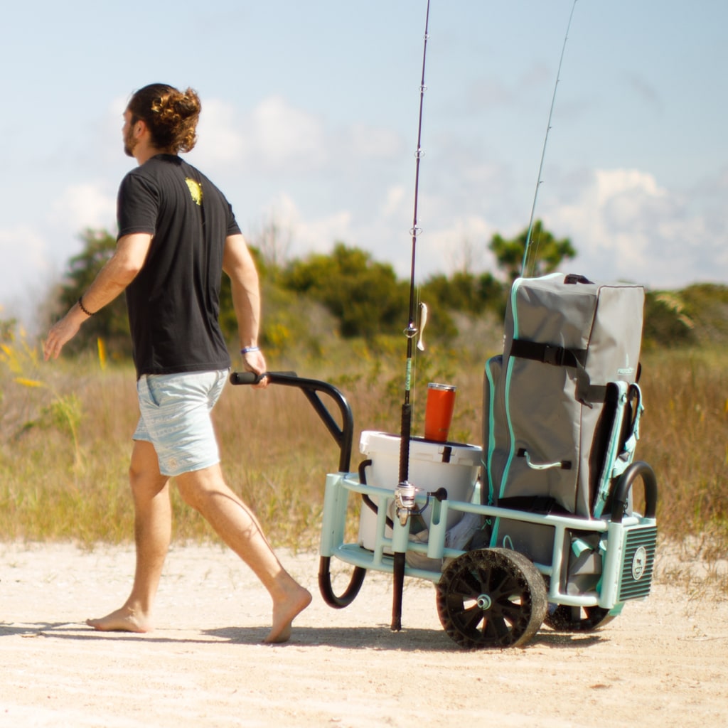 Man pulling full Mure Cart on the beach